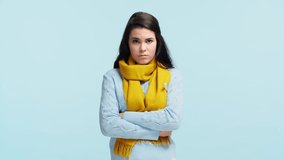 sad ill girl in scarf measuring temperature isolated on blue