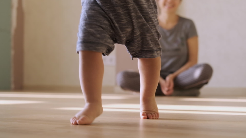 Little feet walking on floor, close-up. Baby learning to walk at home. Baby first steps. Slow motion | Shutterstock HD Video #1041723451