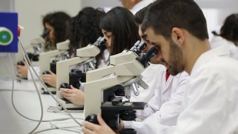 LEBANESE UNIVERSITY, LEBANON - 2015: Medicine students at lab looks throught microscopes, Faculty of Medicine. The Lebanese University is the only public institution for higher learning in Lebanon.