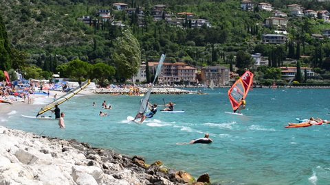 Torbole - Nago, Lago di Garda (Lago Benaco), Italy - July 18, 2019: Beach with tourists in the city Torbole - Nago. 