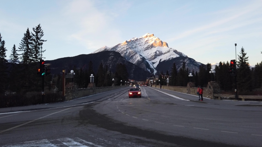 Bow River bridge in Banff, Alberta sits beneath Cascade Mountain
