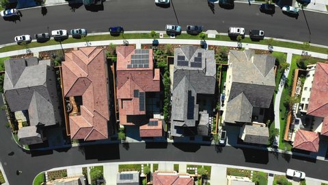 Birds eye aerial of houses with solar panels. Renewable energy on neighborhood homes