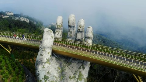 Ba Na Hills / Vietnam - 03 08 2019: Golden Bridge in Ba Na Hills in Vietnam aerial view of giant hand pillar.