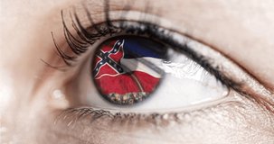 Woman green eye in close up with the flag of Mississippi state in iris, united states of america with wind motion. video concept