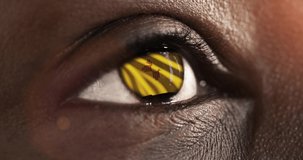 Woman black eye in close up with the flag of New Mexico state in iris, united states of america with wind motion. video concept