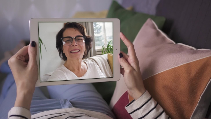Young woman having video call via tablet talking to mom. friends, facetime, online, internet, long distance communication, chatting concept. skype chatting with grandmother | Shutterstock HD Video #1041766174