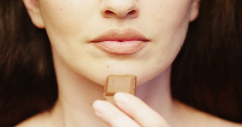 Female Eating Chocolate Bar a close up of Woman Lips Indulging in the Taste of Food