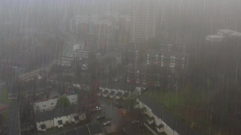Aerial footage taken in heavy rain on a very foggy day flying through a residential housing estates in the Leeds City Centre in West Yorkshire UK,  showing a British city and town in a bad storm