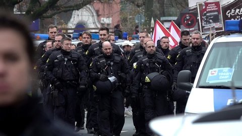Hannover, Germany, November 23., 2019: Group of German policemen in black uniforms protects the small demonstration of right-wing radicals