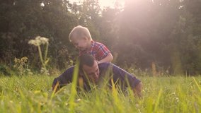 dad and son happy family play push ups slow motion funny video. father lifestyle man and son little a boy push ups in nature laugh and play