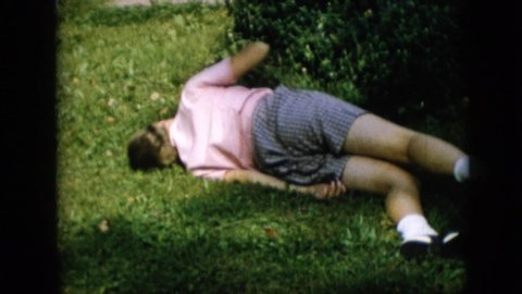 PENNSYLVANIA-1957: A Girl Laying On The Lawn Rolls And Spanks Herself