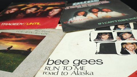 Rome, Italy - November 18, 2019: 45 rpm covers of the BEE GEES group. composed of the brothers Barry, Robin and Maurice Gibb, the most successful artists in the history of music with over 230 million