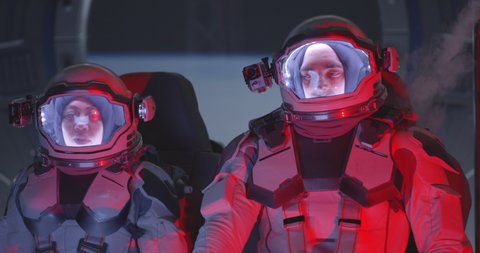 Medium shot of two astronauts experiencing increased g force in accelerating spaceship