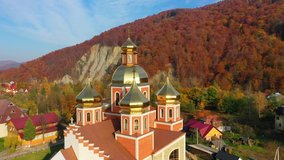 4K Aerial drone video of Orthodox Church with gilded domes in Yaremche in Carpathians mountains