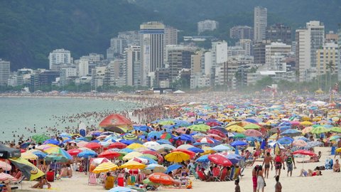 Rio de Janeiro, Brazil - December 21: Locket shot of people bathing and colourful sun umbrellas at famous Ipanema Beach during summer in Rio de Janeiro, Brazil. 