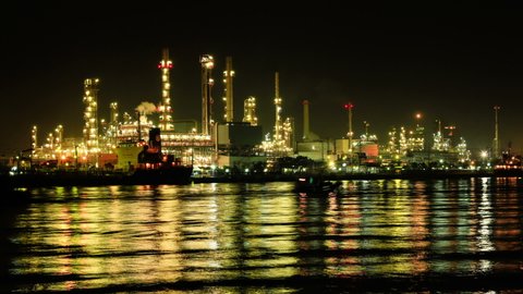 Oil refinery factory beside the river timelapse