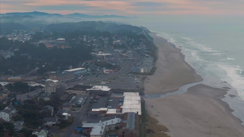 Aerial over sandy beach front and residential houses in Lincoln City, Oregon, USA 