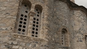 Ancient Agios Dionysios monastery facade on Olympus mountain 4K tilting video