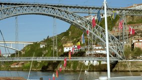 Static clip of Luís I Bridge with people walking on the top deck and traffic on lower deck in Porto, Portugal