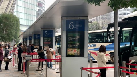 Tokyo , Tokyo / Japan - 10 08 2018: People waiting and lineup at bus stop terminal front to Yaesu Central entrance-exit of Tokyo Station.