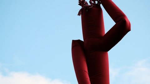 Inflatable aeroman pipe, dancing over a blue sky.