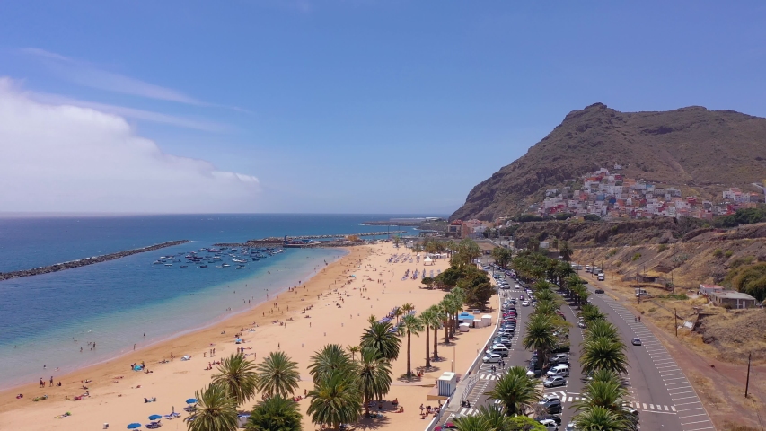 Aerial view of Las Teresitas beach, road, cars in the parking lot, golden sand beach and the Atlantic Ocean. Tenerife, Canary Islands, Spain