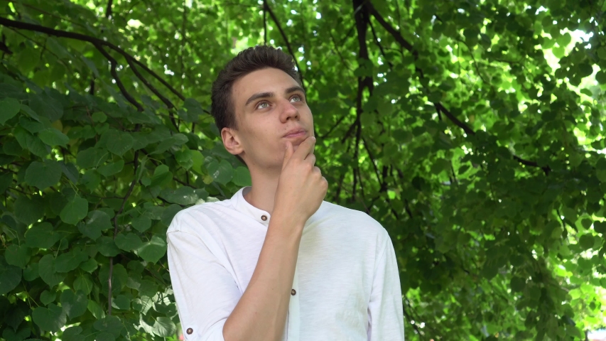 Boy is thinking in the park 