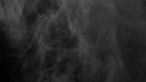 White Haze Shroud Rises. The residual stream of white smoke slowly shrouds up on a black background