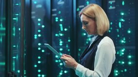 Blonde woman IT chief engineer using a digital tablet web hosting and networking running backup inspecting a server room in cyber security. Data center professional. - Powered by Shutterstock - Get 15% off with code: PIKWIZARD15