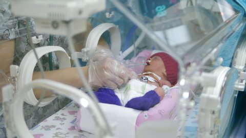 Nurse listens to newborn baby heart.