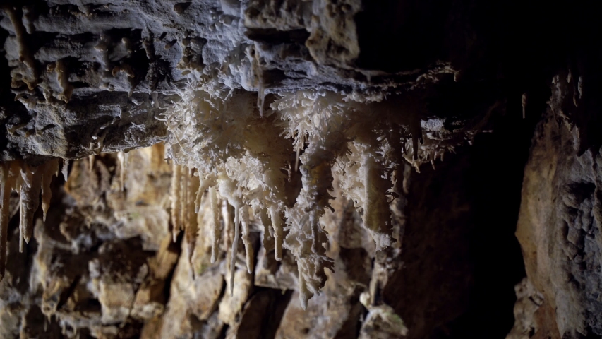Beautiful giant cave with mysterious light. Stalactites and stalagmites illuminated by beautiful changing light. Giant grotto underground. Underground Kingdom. Journey to the center of the earth.