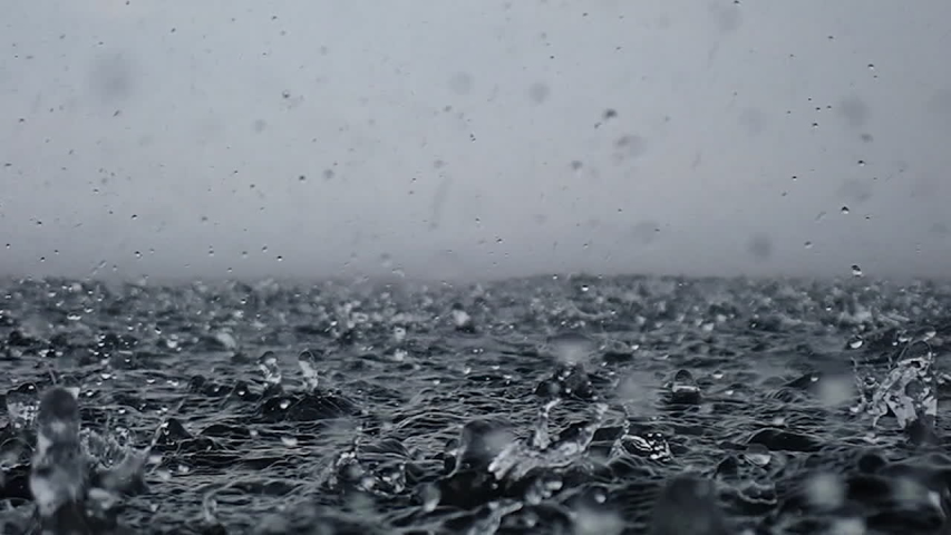 Rain drops into the endless ocean, close up. It briefly bounces back to the air after it hits the sea surface, slow motion. | Shutterstock HD Video #1041866467