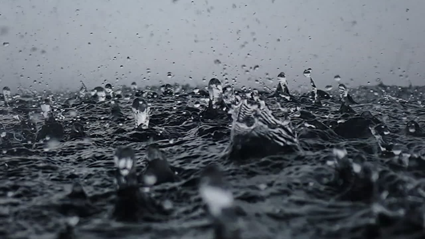 Rain drops into the endless ocean, close up. It briefly bounces back to the air after it hits the sea surface, slow motion. | Shutterstock HD Video #1041866467