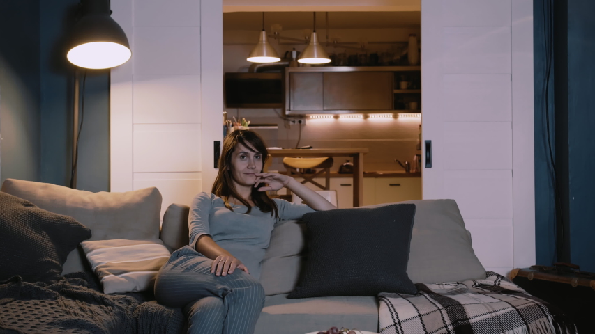 Happy young European family with two kids gather on couch to watch TV at home smiling. Togetherness and entertainment. | Shutterstock HD Video #1041877690