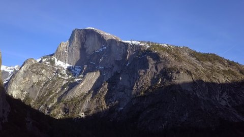 Aerial Shot approaching Half Dome in Yosemite National Park during Sunset.