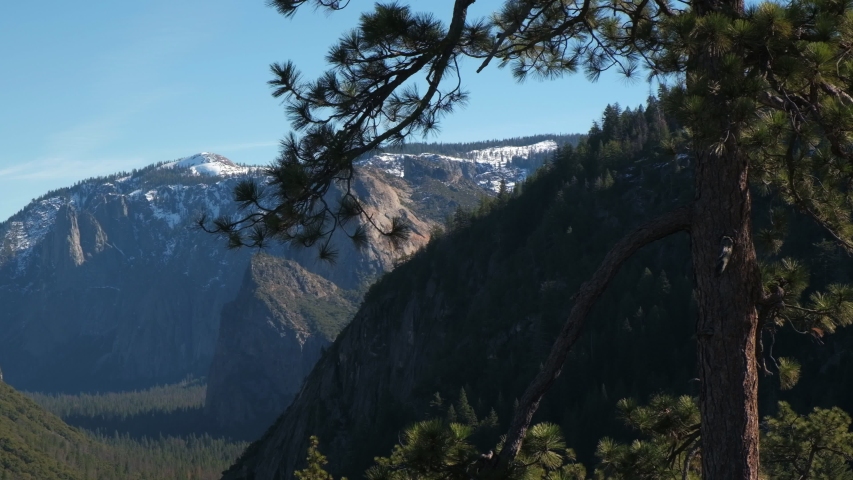Camera pans across Yosemite Valley - El Capitan and Half Dome in the Distance.