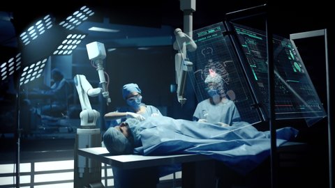 Team of Surgeons Perform a Delicate Operation using a Double Arm Medical Surgical Robot while Observing Data on Transparent Screens. Modern Medical Equipment. Robotic Arm for Minimal Invasive Surgery.