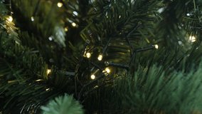 Sparkles of LED lights on artificial Christmas tree 4K video