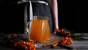 Glass teapot with herbal sea buckthorn tea. cinemagraph looped video