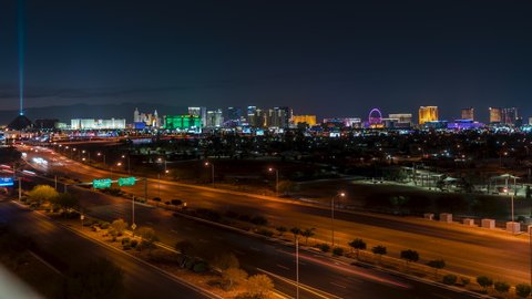Las Vegas Strip skyline timelapse with airplanes departing and busy car traffic