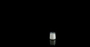 Glass of Milk Bouncing and Splashing on Black Background, Slow Motion 4K