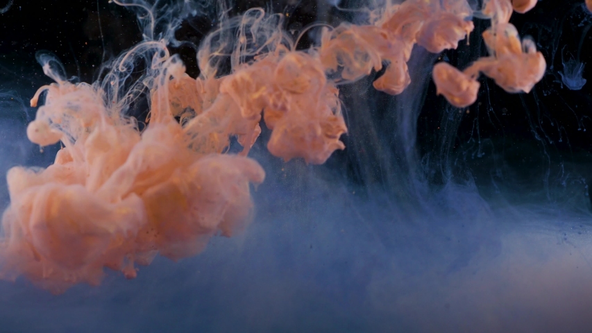 Movement and mixing, abstract footage with movement and mutual penetration. The fusion of two different colors. Paint or ink in water