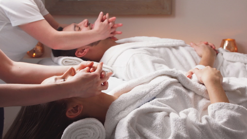 Charming modern couple enjoying a face massage in wellness salon. Relaxing and health. | Shutterstock HD Video #1041907690