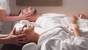 Charming modern couple enjoying a face massage in wellness salon. Relaxing and health. - Powered by Shutterstock - Get 15% off with code: PIKWIZARD15
