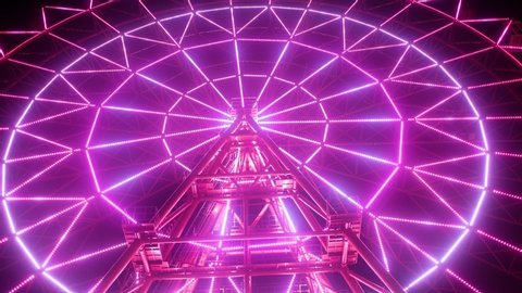 Ferris wheel illuminated at night. Carousel lights in the park