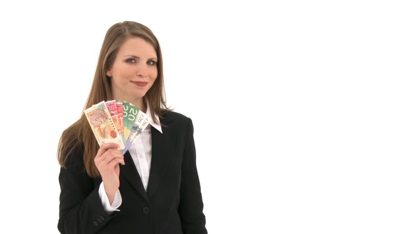 Woman stands in front of white background and fans herself with banknotes 