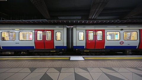LONDON - AUGUST 21, 2019: A London tube train pulling away from Monument Underground Station