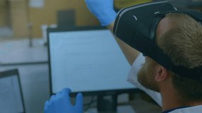 Animation of data processing with male scientist in VR headset touching with his finger sitting by a computer screen - Powered by Shutterstock - Get 15% off with code: PIKWIZARD15