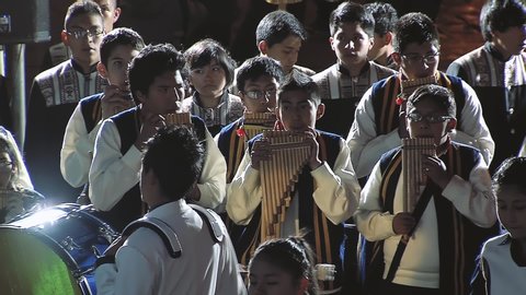 La Paz / Bolivia - 09 09 2019: Group of Teenagers Playing Andean Instruments (Siku, an Andean Pan Flute) and Dancing at Night in a Public Square of La Paz, Bolivia. 