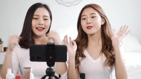 Portrait of young asian woman review giveaway gift product fan following channel, recording video make up lipstic cosmetic at home. Beauty blogger present beauty cosmetics